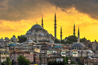 View of buildings in city against sky during sunset