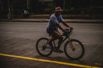 Man riding bicycle on street