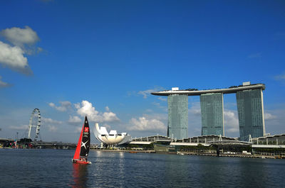 Ship in sea against sky in city