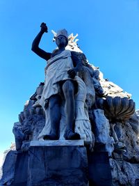 Low angle view of statue against blue sky