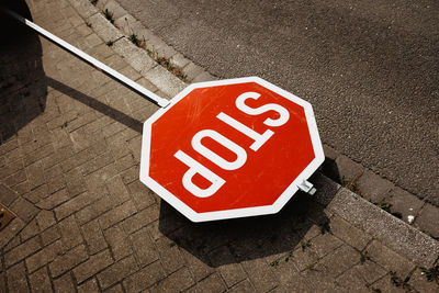 High angle view of road sign on street