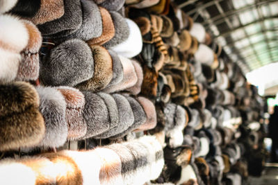 Fur hats hanging at market for sale