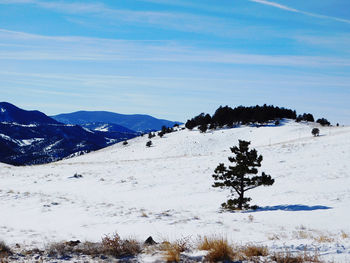 Scenic view of snow covered mountains against sky