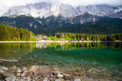 Scenic view of lake and mountains against sky