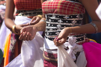 Midsection of couple holding hands