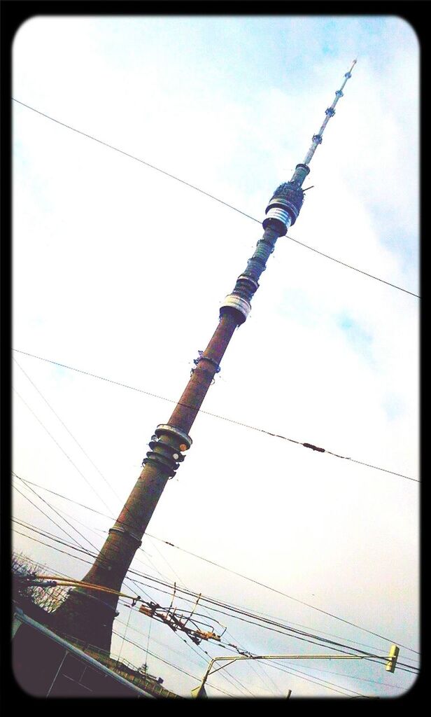 low angle view, transfer print, power line, sky, cable, auto post production filter, electricity, power supply, connection, lighting equipment, electricity pylon, street light, technology, hanging, power cable, outdoors, pole, no people, day, built structure