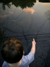 Rear view of boy in lake