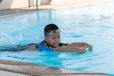 Portrait of boy swimming in pool