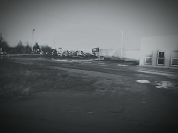 Empty road along buildings