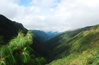 Scenic view of mountains against cloudy sky