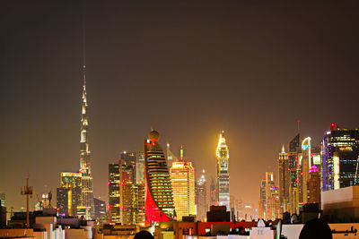 Illuminated buildings in city at night