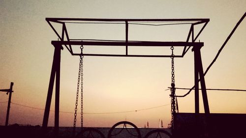 Low angle view of silhouette built structure against sky