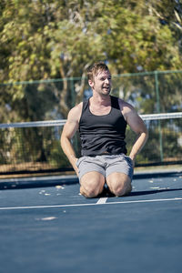 Young man exercising on basketball court