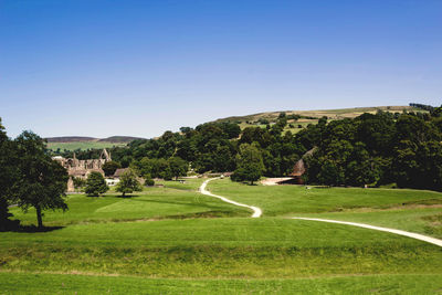 View of golf course against clear sky
