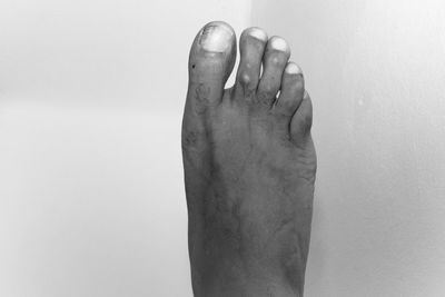 Low section of woman against white background