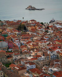 High angle view of townscape by sea against sky