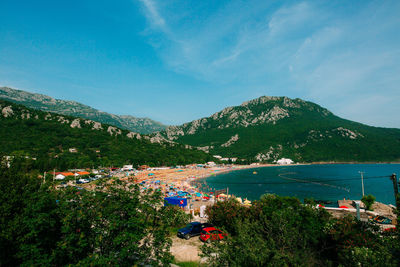 High angle view of buildings by sea against sky