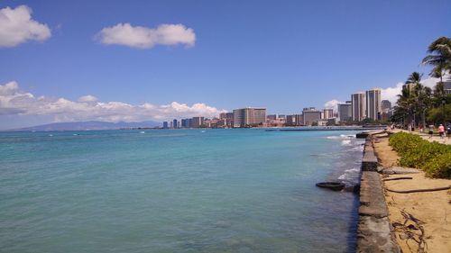 Scenic view of sea and buildings against sky