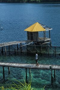 High angle view of man on pier by sea