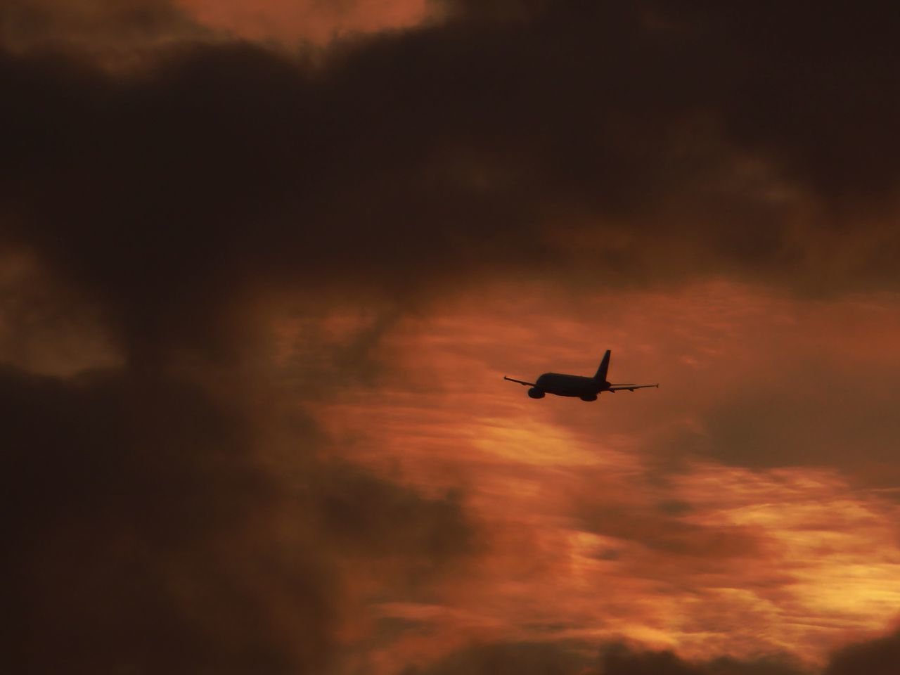 SILHOUETTE AIRPLANE FLYING AGAINST SKY