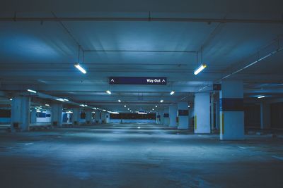 Illuminated underground walkway at night