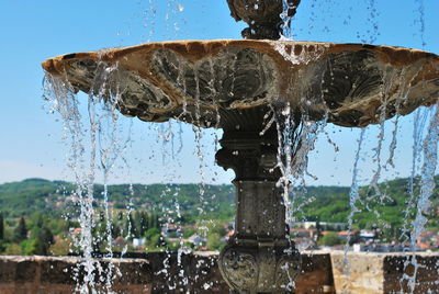 Close-up of water splashing from fountain against clear sky