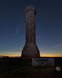 Low angle view of old ruin on field against sky at night