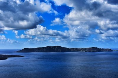 Panoramic view of sea and mountains against blue sky