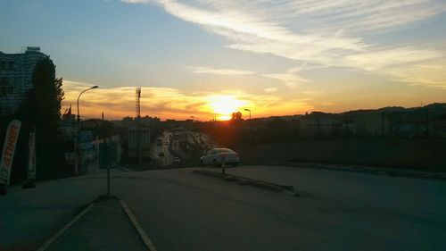 View of residential district against cloudy sky at sunset