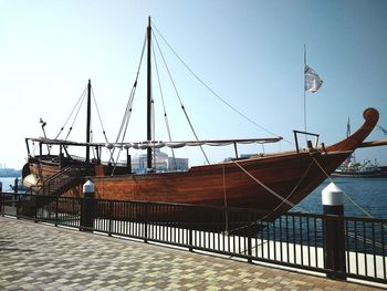 Ship moored in sea against clear sky