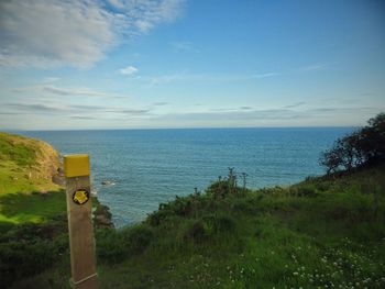 Scenic view of sea against cloudy sky