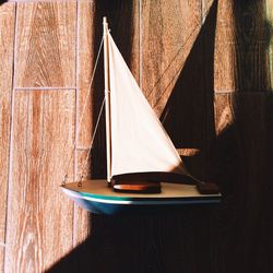 Sunlight falling on boat figurine on table