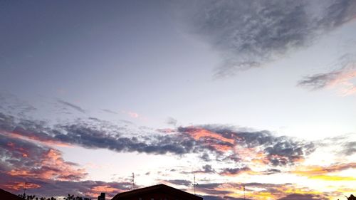 Low angle view of silhouette buildings against sky during sunset