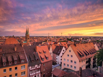 Townscape against cloudy sky during sunset