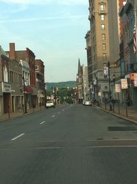 City street and buildings against sky