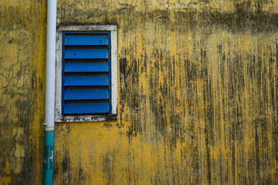 Blue window on yellow wall