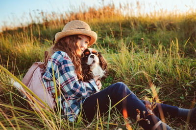 Dog sitting on field