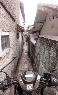 Narrow alley amidst buildings against sky