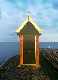 Built structure on beach against sky