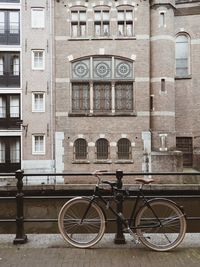 Bicycle parked against building