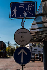 Information sign on road against sky