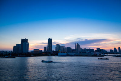 Buildings in city at sunset