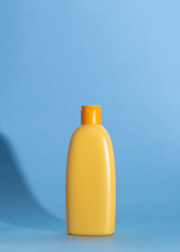 Close-up of bottle against blue background