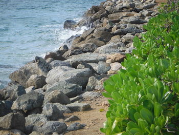 Rocks on beach against sky