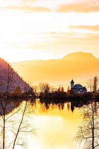 Scenic view of lake against sky during sunset