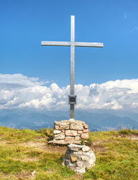 Peak of mountain with cross for memory to victims. manrvelous day in summer