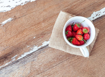 High angle view of strawberries in bowl on table