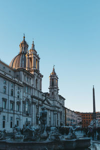 Low angle view of cathedral at piazza navona against clear sky