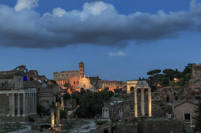 Old buildings in city against sky at dusk