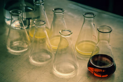 Close-up of liquids in beakers on table 